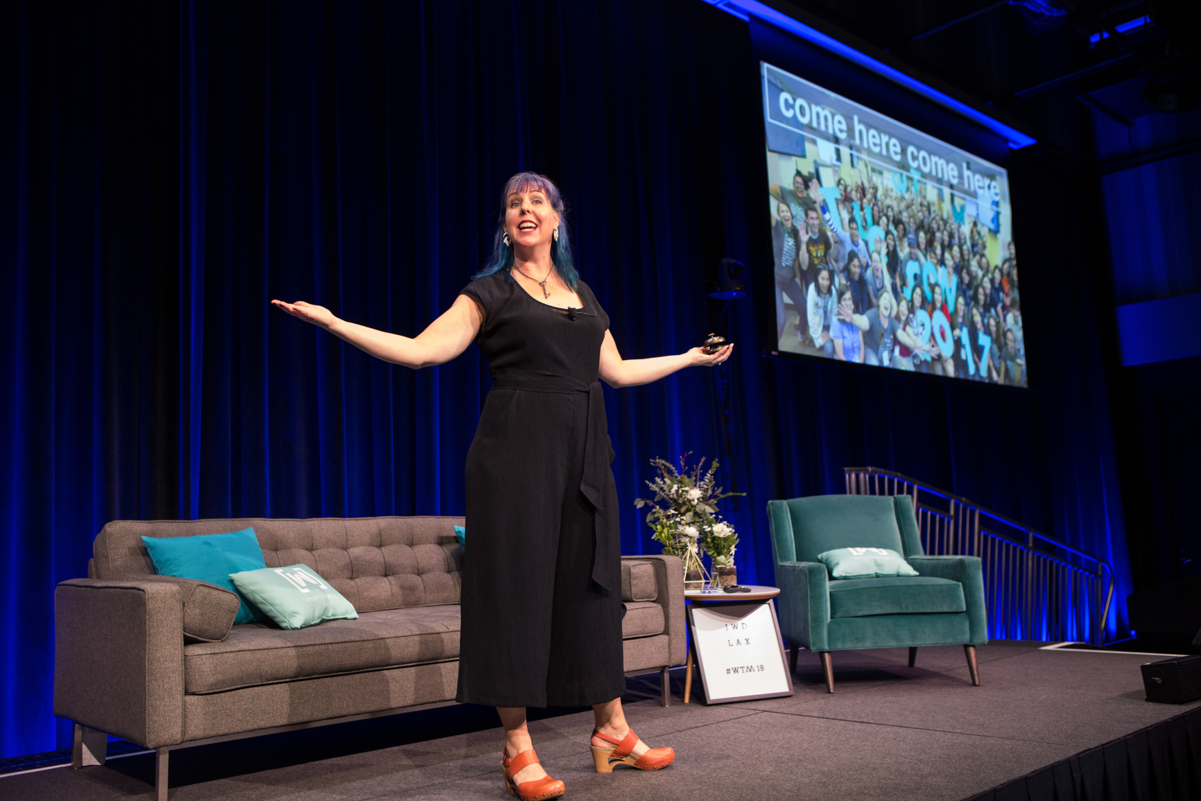 Photo of Kimberly on stage training 100s of women