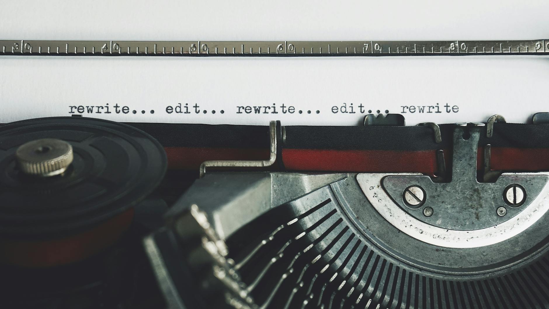 Very close up of a typewriter with the word  edit...rewrite...edit..". repeated. 
Photo by Suzy Hazelwood on Pexels.co